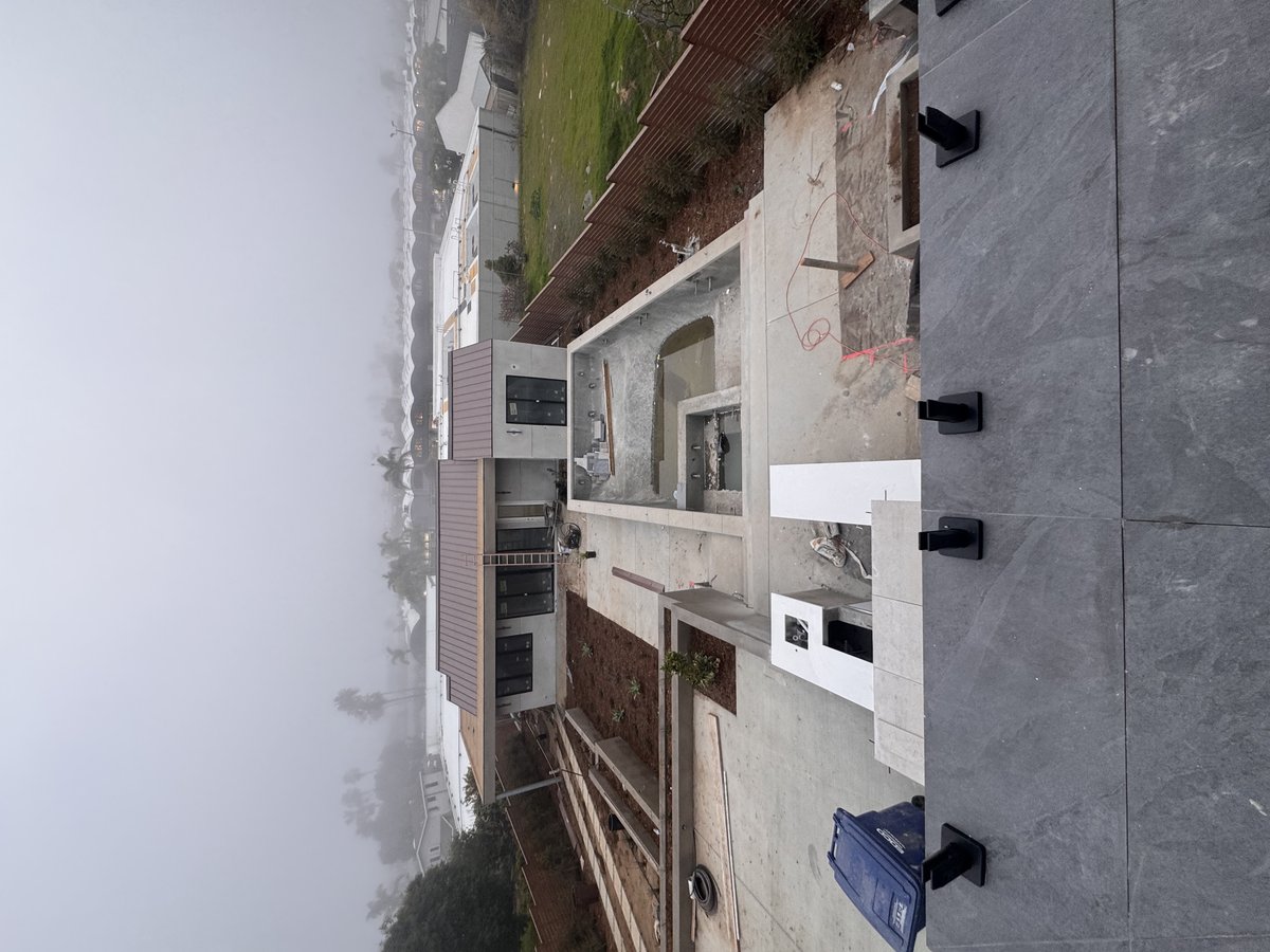 Near-complete modern exterior with concrete and tile — February 2025