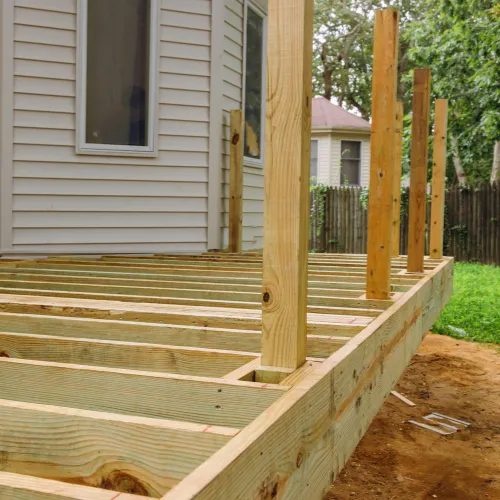 Deck framing in progress with posts and joists
